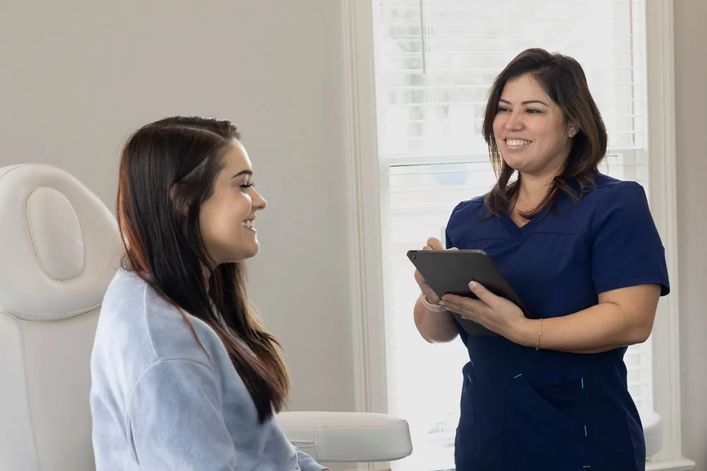 A member of the ESJ Aesthetics team with a patient